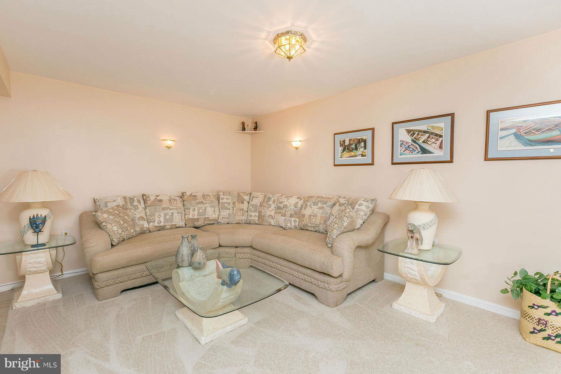 7803 Poplar Grove Road Severn, MD 21144 - Photo 22 of 30 a living room with furniture and a wall painting