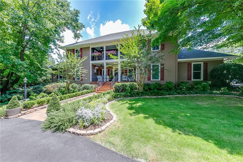 6180 Old Jefferson Road Athens, GA 30607 - Photo 11 of 100 a front view of a house with a yard and potted plants