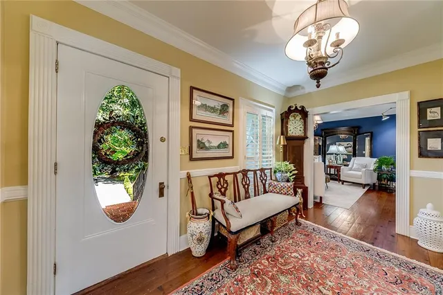 a dining room with furniture a chandelier and window