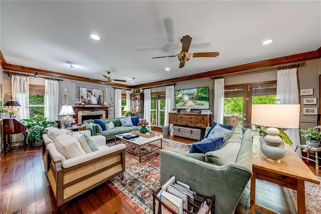 a living room with furniture and a floor to ceiling window
