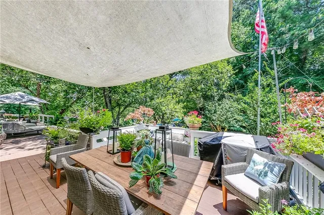 a view of a porch with furniture and garden