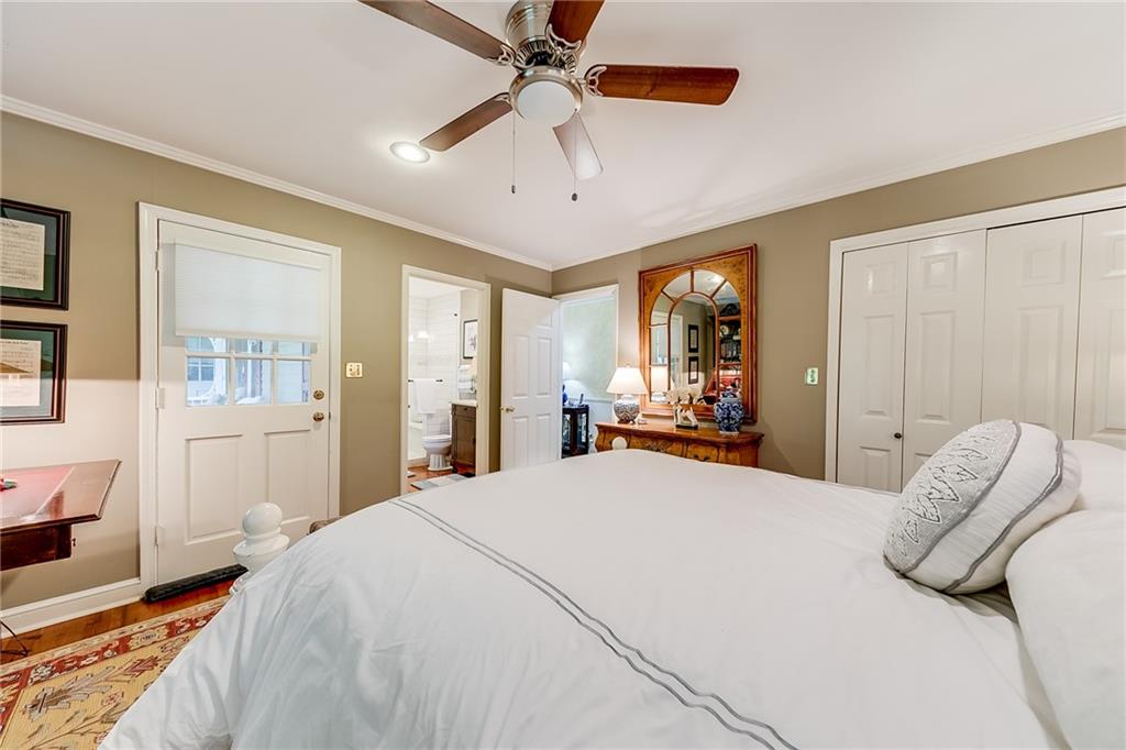 6180 Old Jefferson Road Athens, GA 30607 - Photo 50 of 100 a bedroom with a large bed and a chandelier