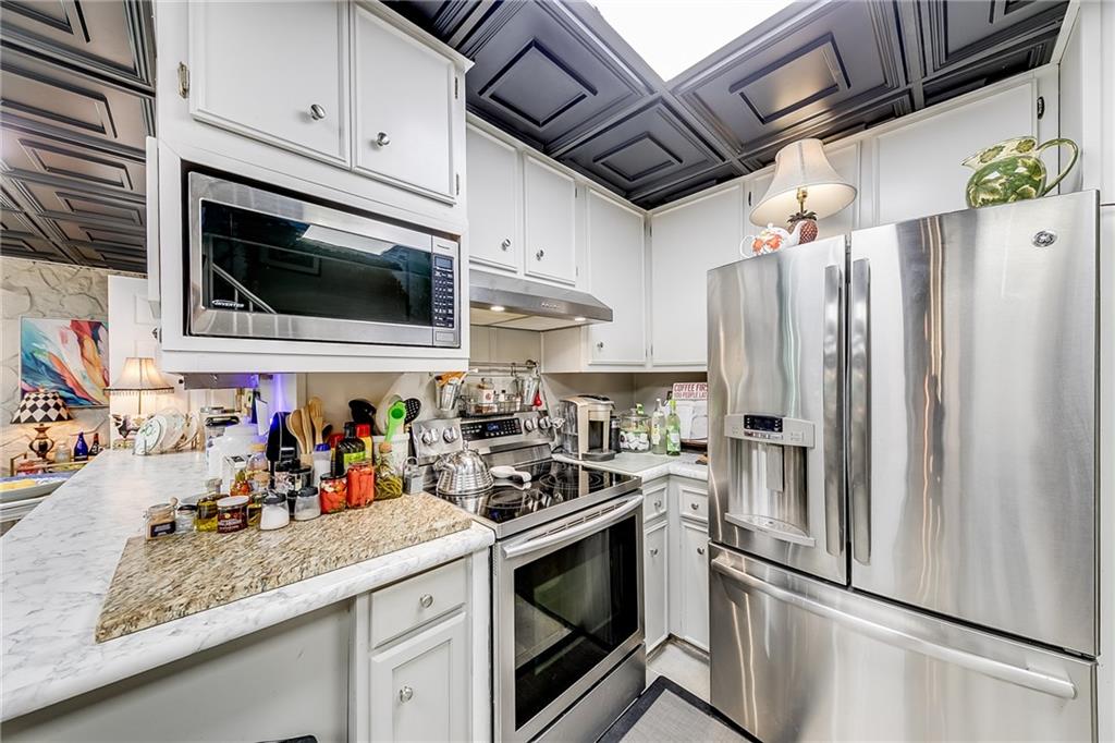 6180 Old Jefferson Road Athens, GA 30607 - Photo 65 of 100 a kitchen with stainless steel appliances a stove microwave and refrigerator
