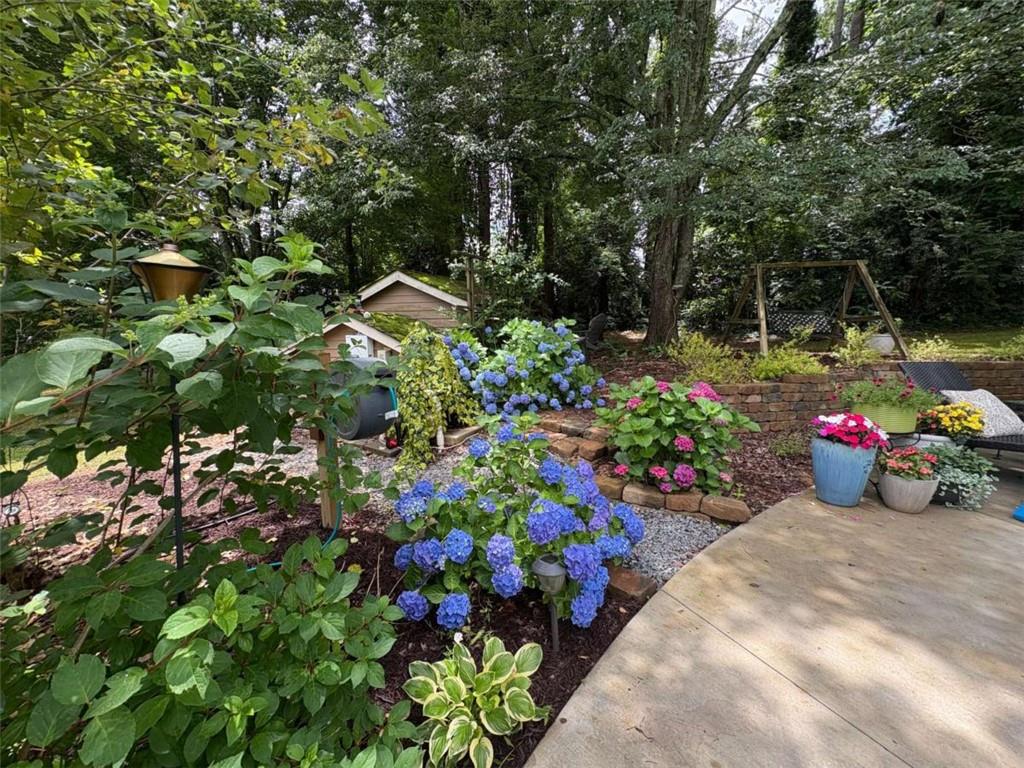 6180 Old Jefferson Road Athens, GA 30607 - Photo 75 of 100 a view of a garden with flowers and trees