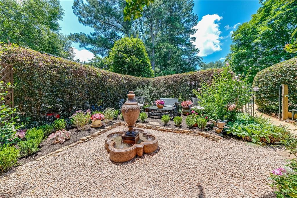 6180 Old Jefferson Road Athens, GA 30607 - Photo 88 of 100 a view of a backyard with table and chairs potted plants and large tree