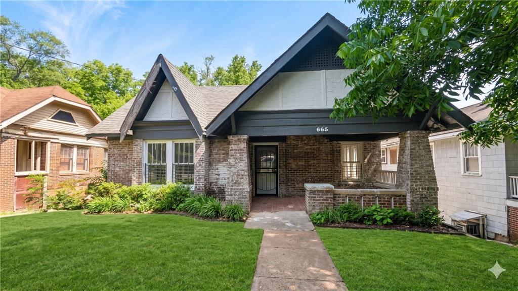 665 Lexington Avenue Southwest Atlanta, GA 30310 - Photo 1 of 33 a front view of a house with a yard