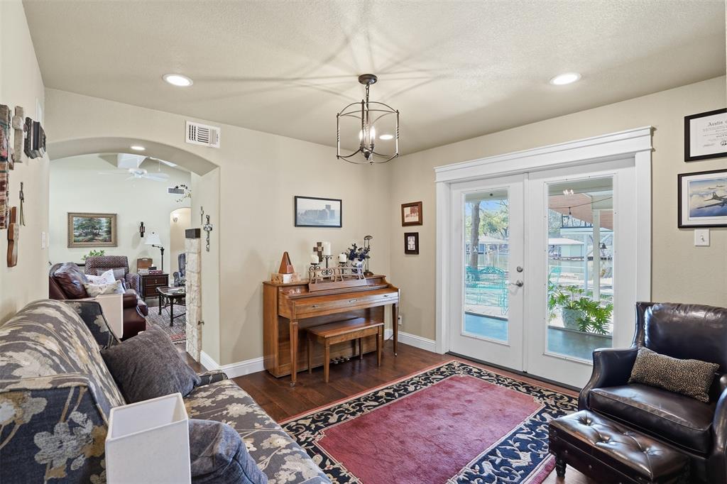 5014 Mohawk Court DeCordova, TX 76049 - Photo 12 of 36 a living room with furniture a chandelier and a rug
