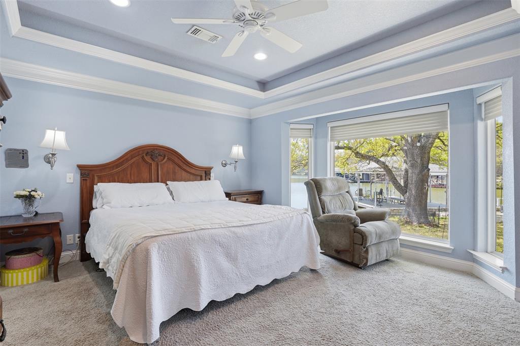 5014 Mohawk Court DeCordova, TX 76049 - Photo 13 of 36 a bedroom with a bed couch and a large window