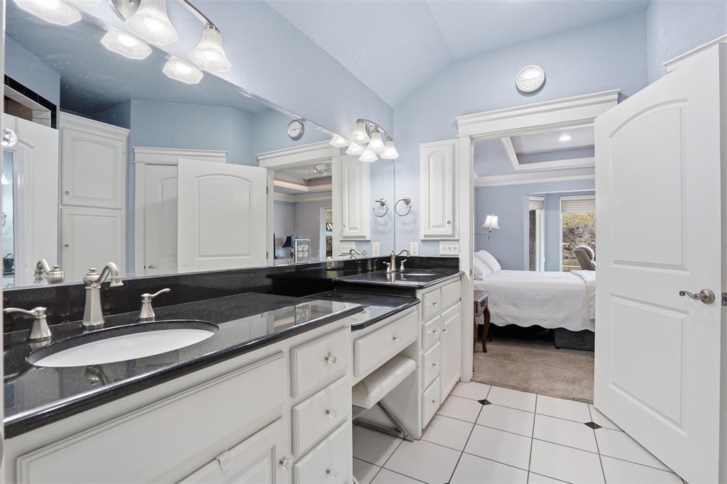 5014 Mohawk Court DeCordova, TX 76049 - Photo 15 of 36 a spacious bathroom with a granite countertop sink a mirror and a bathtub