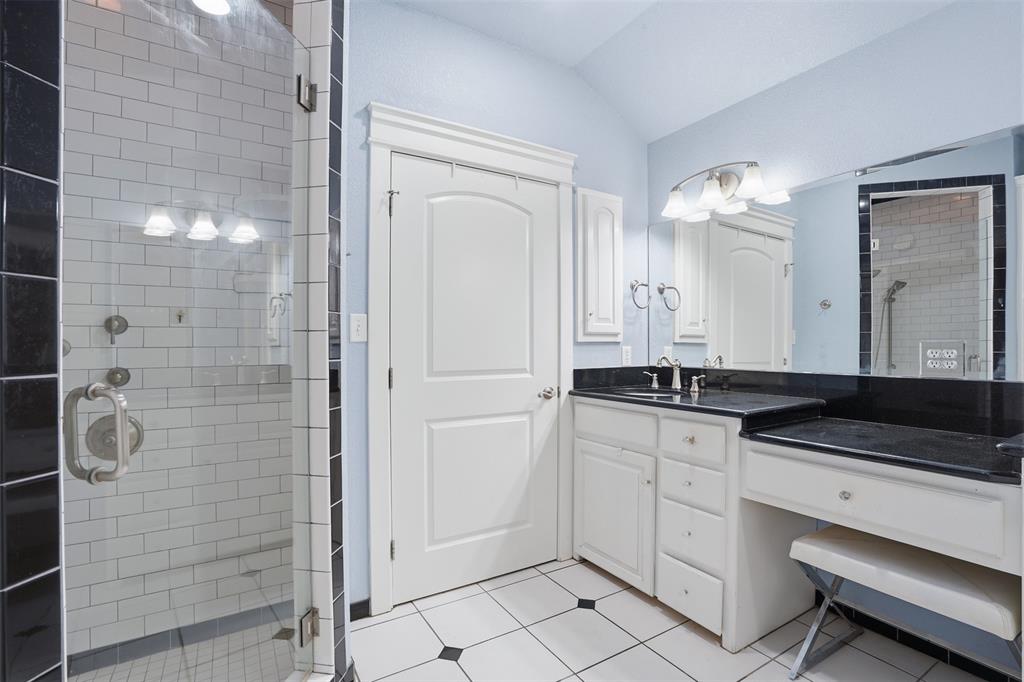 5014 Mohawk Court DeCordova, TX 76049 - Photo 16 of 36 a bathroom with a granite countertop sink a toilet a mirror and shower