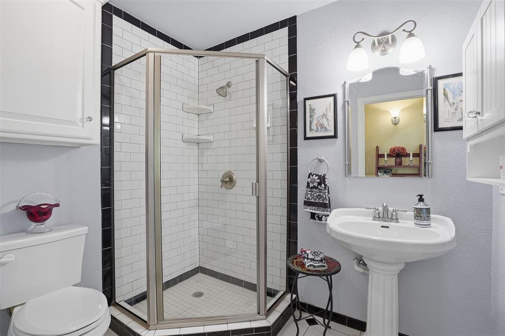 5014 Mohawk Court DeCordova, TX 76049 - Photo 18 of 36 a bathroom with a sink toilet and shower