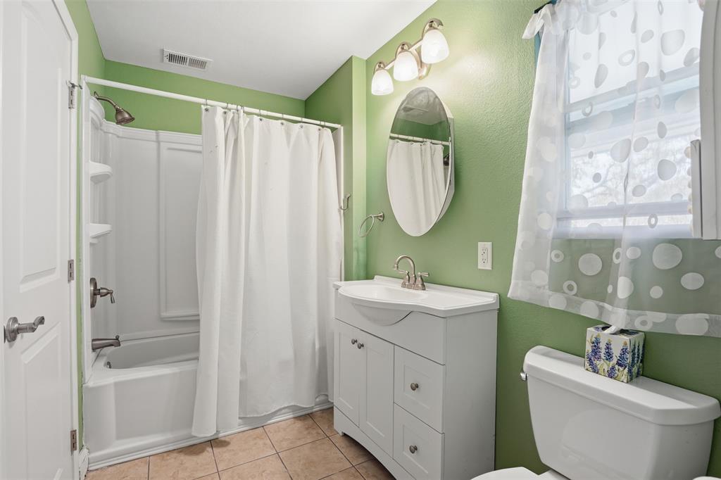 5014 Mohawk Court DeCordova, TX 76049 - Photo 22 of 36 a bathroom with a double vanity sink mirror and toilet