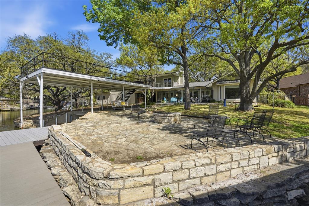 5014 Mohawk Court DeCordova, TX 76049 - Photo 32 of 36 a backyard of a house with lots of green space