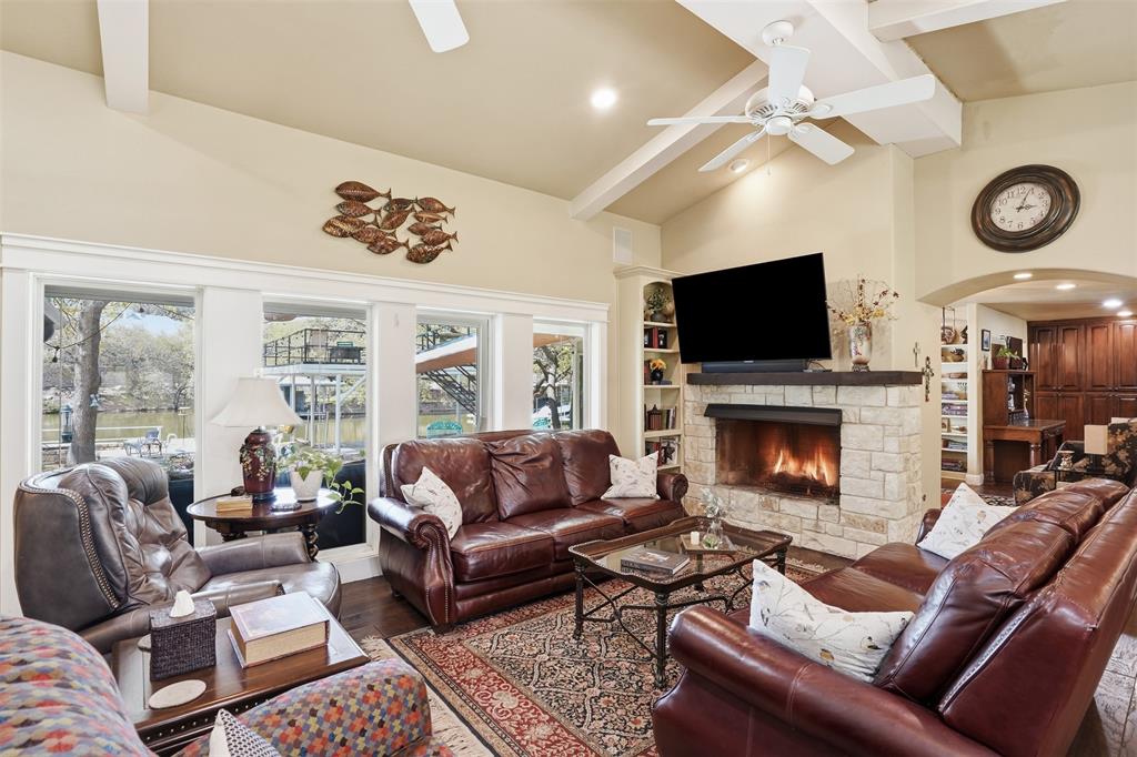 5014 Mohawk Court DeCordova, TX 76049 - Photo 4 of 36 a living room with furniture a fireplace and a flat screen tv