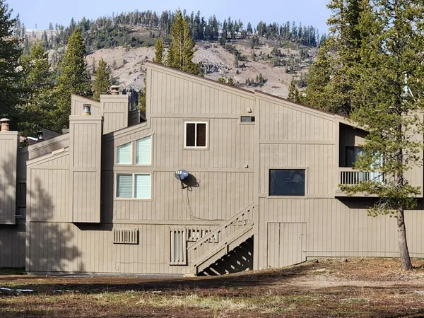 a view of a white house with large windows