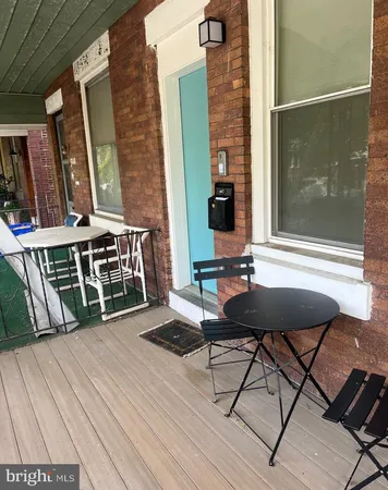 a view of a balcony with table and chairs