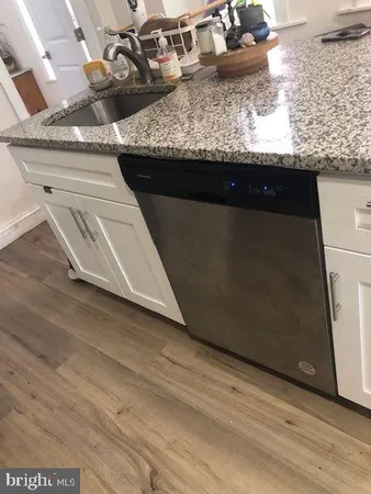 a kitchen with stainless steel appliances granite countertop a stove a sink a refrigerator and a microwave