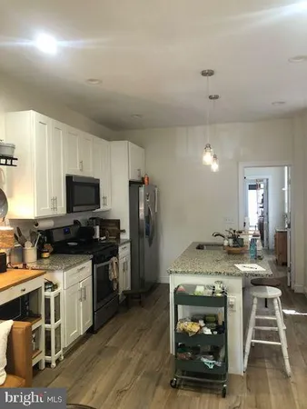 a kitchen with a sink appliances and cabinets
