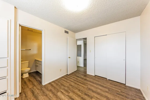 an empty room with wooden floor and a window