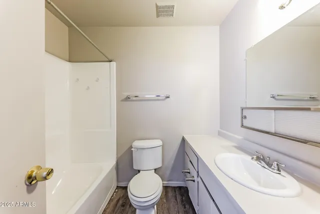 a bathroom with a sink a toilet and shower curtain