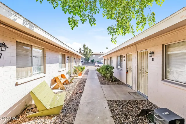a picture of a bench in front of a wall