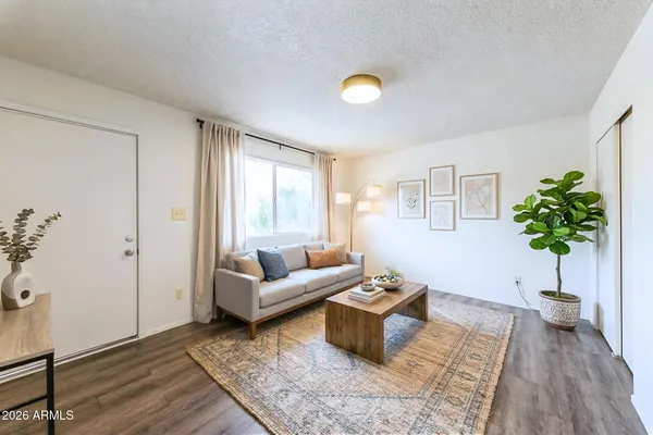 a living room with furniture and wooden floor