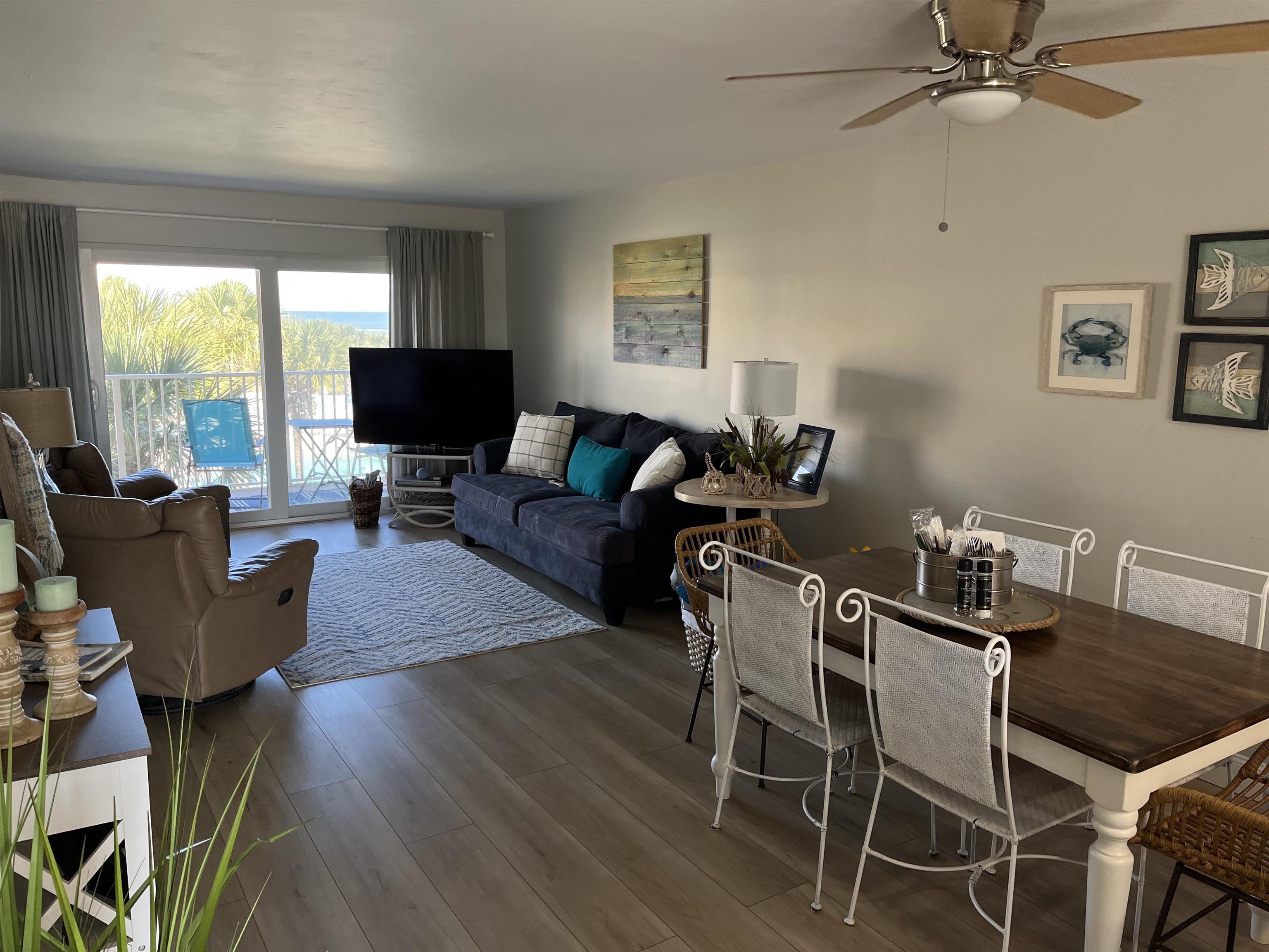 4 Ocean Trace Road, Unit 306 St. Augustine, FL 32080 - Photo 2 of 3 a view of a livingroom with furniture a flat screen tv and wooden floor