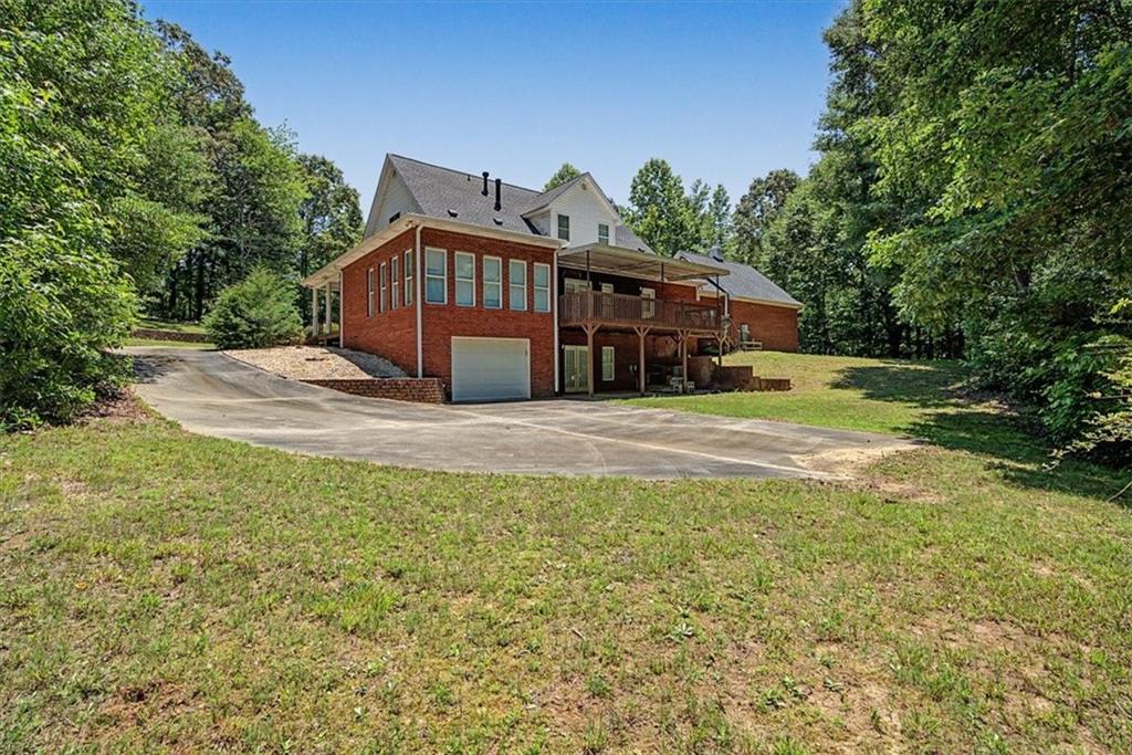 1136 Cole Lake Road Dallas, GA 30157 - Photo 62 of 72 a view of a house with a yard and porch