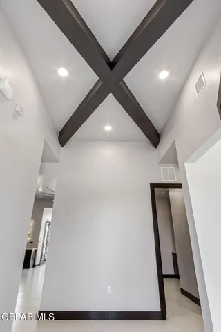 a view of a kitchen with a refrigerator and a sink