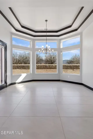 an empty room with closet and windows