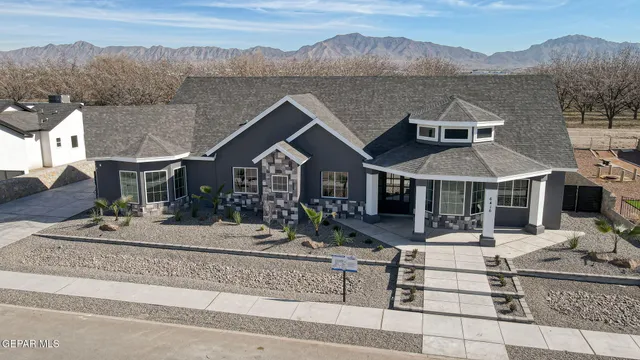a front view of a house with a yard table and chairs
