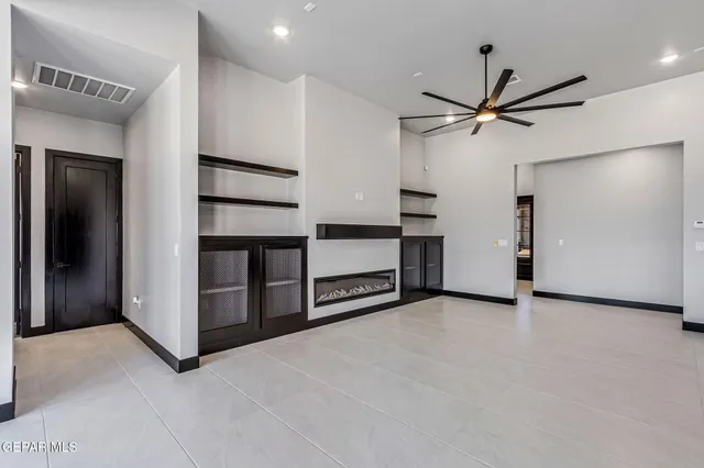 a spacious bedroom with a bed a couch and a window