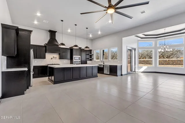 an empty room with a ceiling fan and a fan