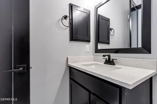 a kitchen with granite countertop stainless steel appliances and wooden cabinets