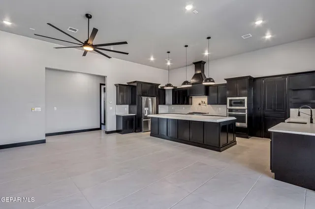 a kitchen with granite countertop a stove and a sink