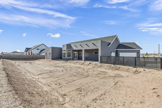 a view of a house with snow on the road