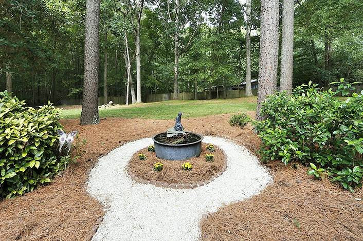 11021 Coachmans Way Raleigh, NC 27614 - Photo 21 of 24 Make a wish in this charming fountain located off the rear deck! Exterior Back