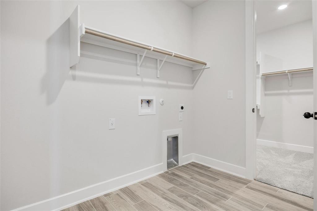 504 Sundance Ridge Georgetown, TX 78628 - Photo 14 of 34 Functional utility space features wood-look tile flooring and integrated storage shelving.