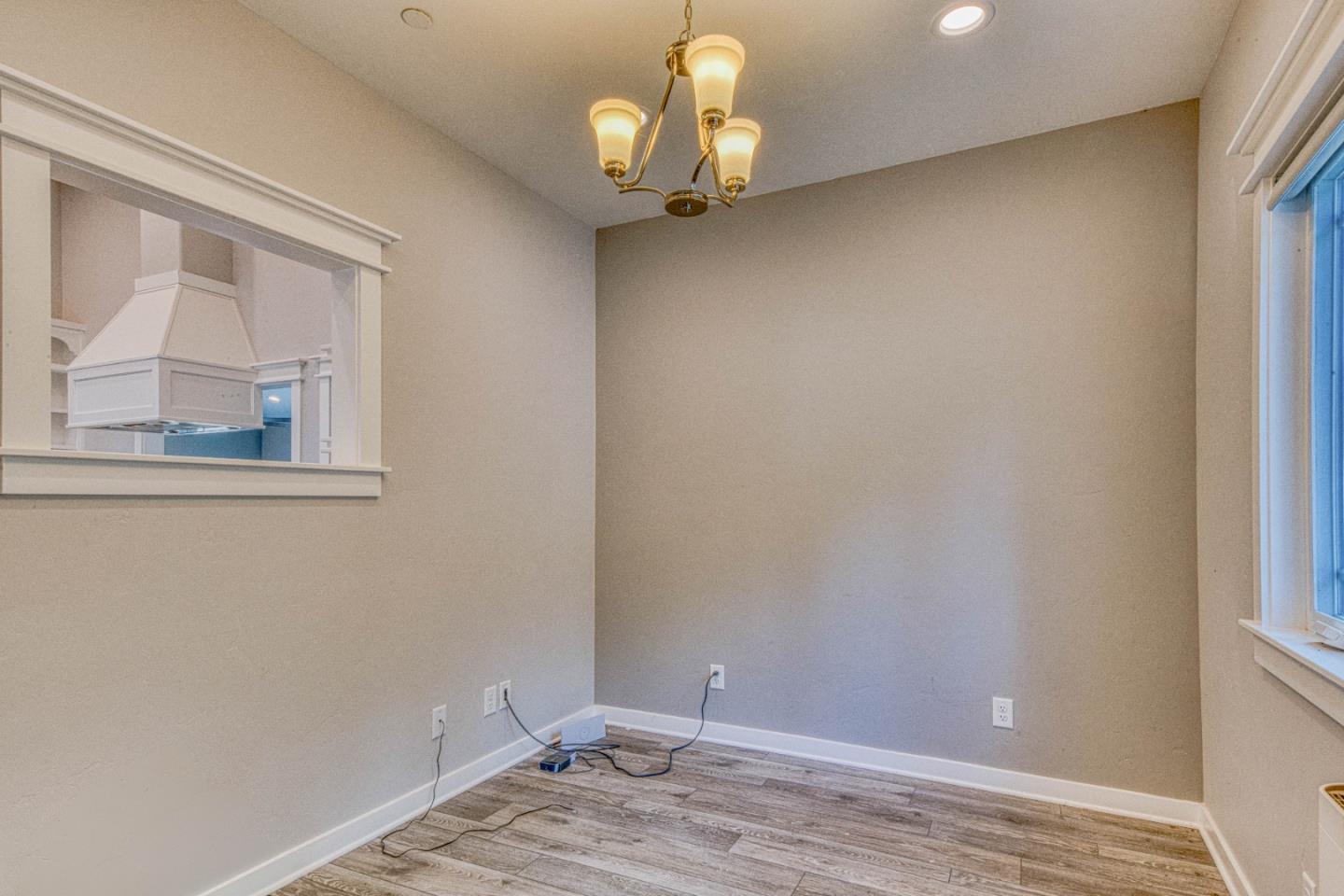 47317 Arroyo Seco Road Greenfield, CA 93927 - Photo 11 of 47 a view of a chandelier fan and wooden floor