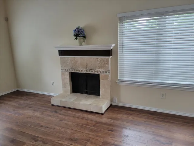 a view of a room that has wooden floor and large window