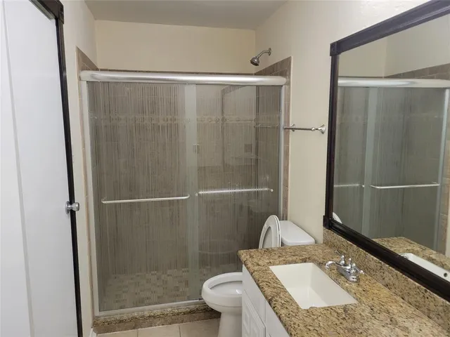 a view of a chandelier fan and fire place