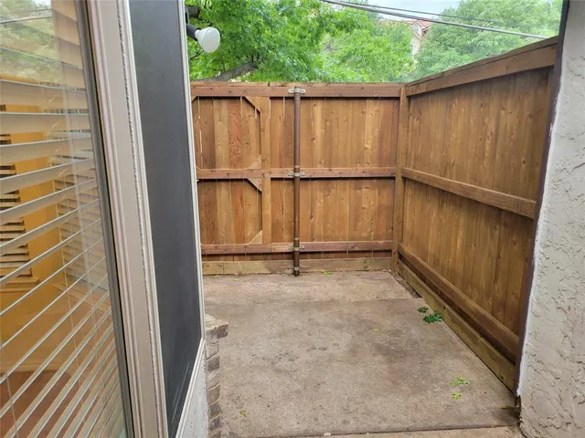 a view of a big room with wooden floor and windows