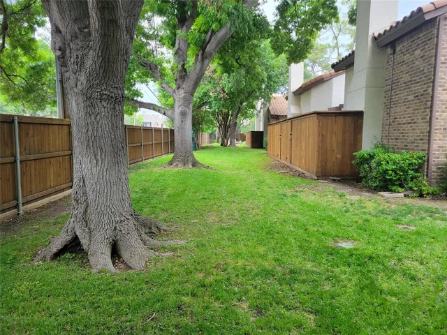 a kitchen with granite countertop a sink stove and refrigerator