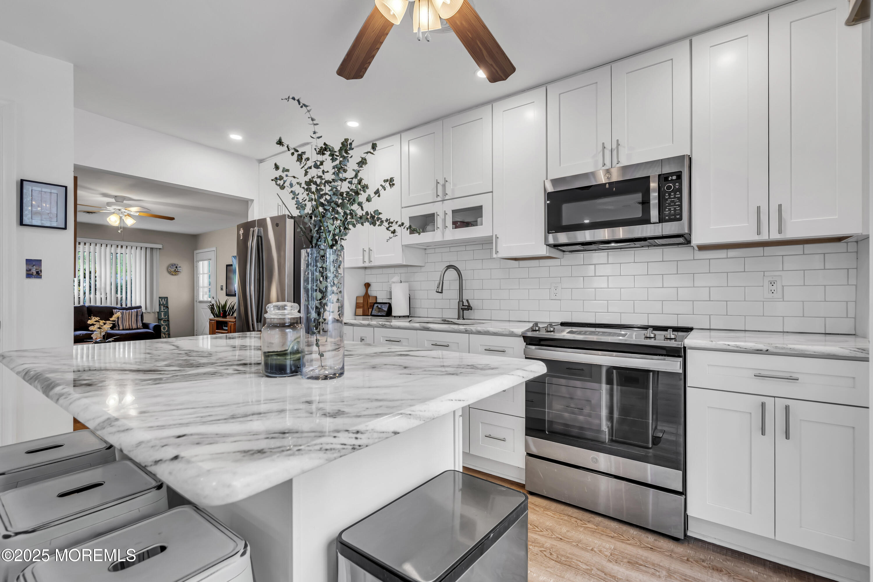 2 Oregon Drive, Unit A Whiting, NJ 08759 - Photo 13 of 26 a kitchen with stainless steel appliances granite countertop a stove sink and microwave
