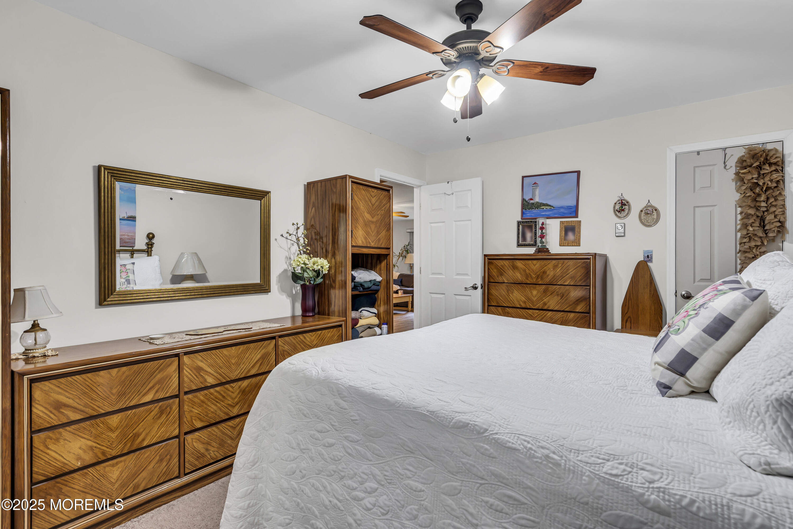 2 Oregon Drive, Unit A Whiting, NJ 08759 - Photo 18 of 26 a bedroom with a bed and a chandelier