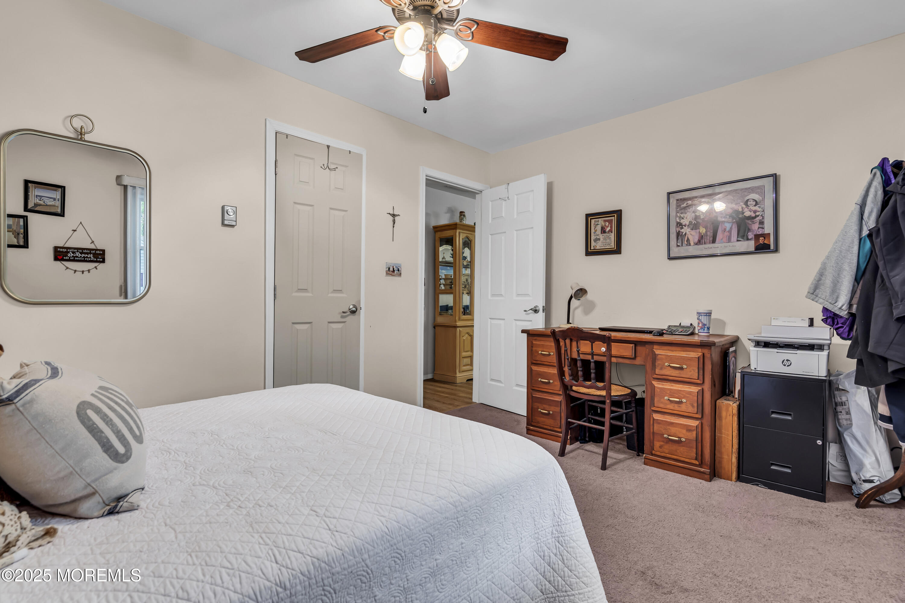 2 Oregon Drive, Unit A Whiting, NJ 08759 - Photo 20 of 26 a bedroom with a bed and a chandelier