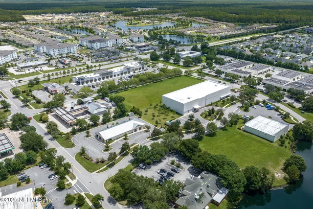an aerial view of a house swimming pool and back yard