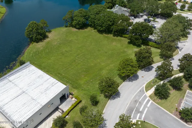 an aerial view of a house with a lake view