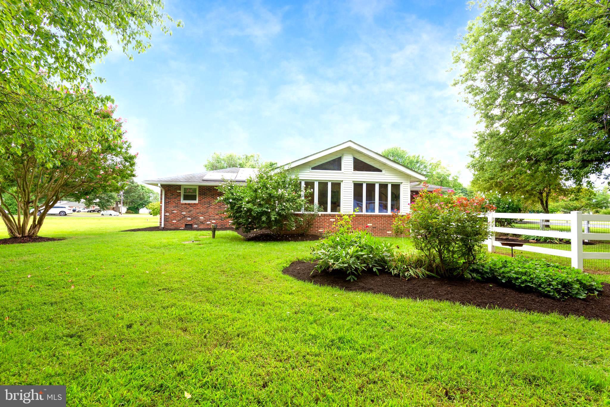 1401 Calvert Road Chester, MD 21619 - Photo 11 of 33 a front view of a house with a yard and trees