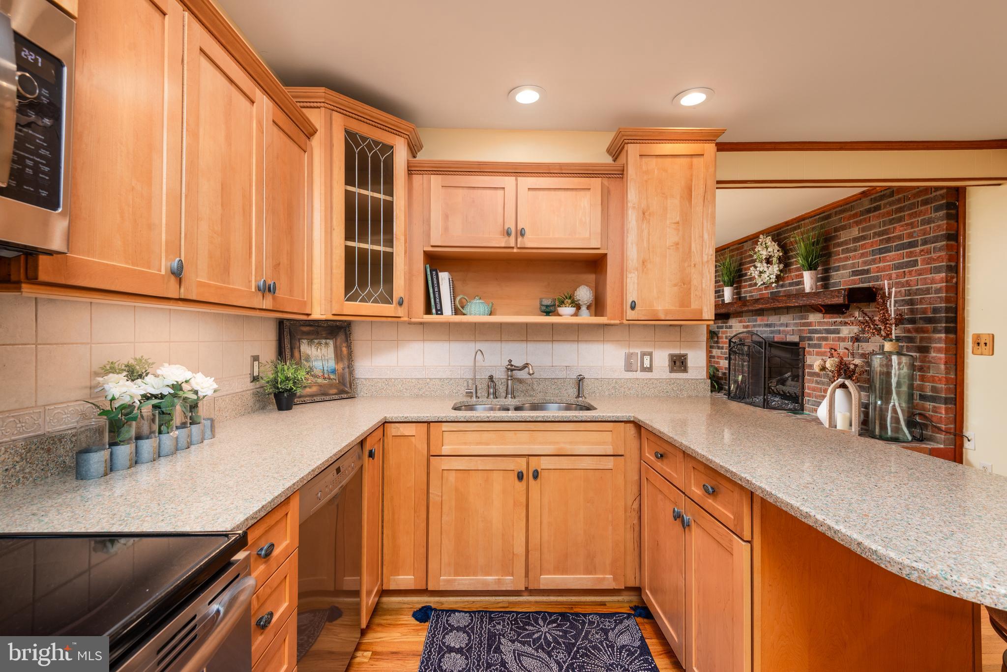 1401 Calvert Road Chester, MD 21619 - Photo 14 of 33 a kitchen with stainless steel appliances a sink a stove a refrigerator cabinets and a counter top space
